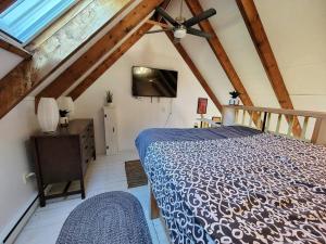 a bedroom with a bed and a ceiling fan at The Davis Loft in Davis