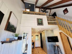 a living room with a staircase and a television at The Davis Loft in Davis