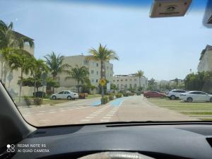 a view from a car window of a street with parked cars at depto relajante Diamante in Acapulco