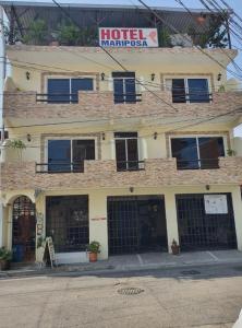 a hotel with a sign on top of a building at HOTEL MARIPOSA in Zihuatanejo
