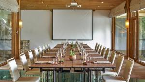 a long table with chairs and a projection screen at Six Senses Ninh Van Bay in Ninh Van Bay