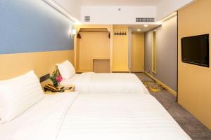 Voodi või voodid majutusasutuse Fu Hua Hotel toas