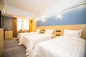 Voodi või voodid majutusasutuse Fu Hua Hotel toas
