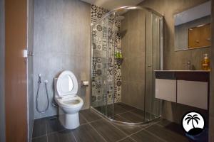 a bathroom with a toilet and a glass shower at Paradise Suite at Asiacity in Kota Kinabalu