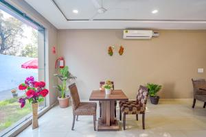 a dining room with a table and chairs at FabHotel Grand Inn in Jalandhar