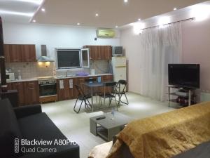 a living room with a couch and a kitchen at Sardinia lux house in Sardínia