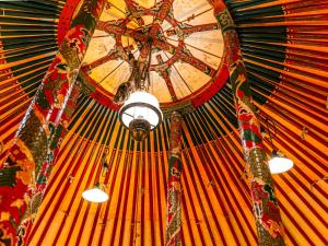 a large orange ceiling with a clock on it at 直島町ふるさと海の家 つつじ荘 -SeaSide Park Stay Tsutsujiso- in Naoshima