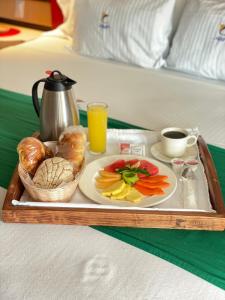 a tray with a plate of food on a bed at Hotel Costa Azul in Acapulco