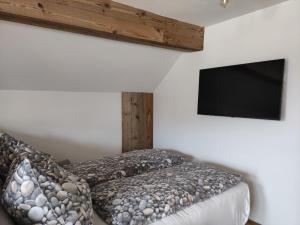 a bedroom with a bed and a flat screen tv at Bauernhof - Appartement beim Zefferer in Schladming