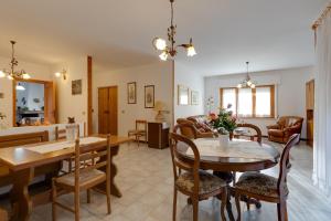 a dining room and living room with a table and chairs at Casa vacanza Sandra in Narbolia