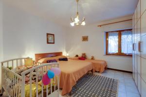 a bedroom with two beds and a crib with balloons at Casa vacanza Sandra in Narbolia