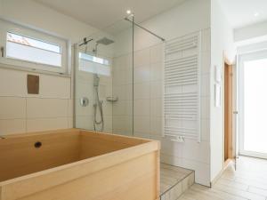 a bathroom with a tub and a shower at Feriendomizil im Luftkurort - Ferienhaus-Sauna-See-Hund in Krakow am See