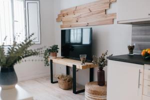 a living room with a tv on a table at Eva Recommends Capilla de la Jura en Jerez in Jerez de la Frontera
