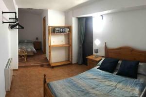 a bedroom with a bed with a blue comforter at Casa Laia in Güéjar-Sierra