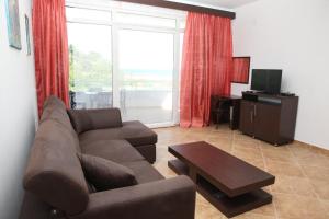 a living room with a couch and a coffee table at Apartments Art in Ulcinj