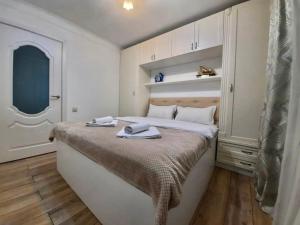 a bedroom with a bed with two towels on it at Квартира на Тулебаева in Almaty