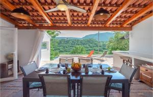 a dining room with a table and chairs with a view at Amazing Home In Zvecanjegata in Zvečanje
