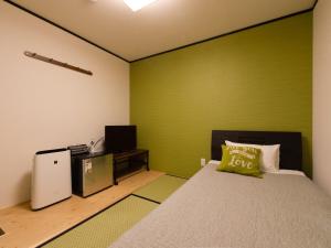 Postel nebo postele na pokoji v ubytování Guest House Suzumeno Kakurembo