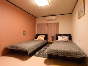 Postel nebo postele na pokoji v ubytování Guest House Suzumeno Kakurembo