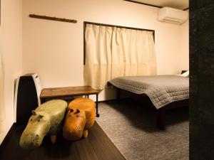 Postel nebo postele na pokoji v ubytování Guest House Suzumeno Kakurembo