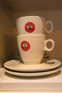a white coffee cup and saucers on a table at Oud Gemeentehuis in Poelkapelle