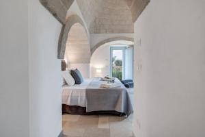 Postel nebo postele na pokoji v ubytování Trulli Gianpaolo - Luxury Villa