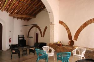 a group of chairs and tables in a room with arches at Casa da Estalagem - Turismo Rural in Ervidel