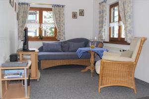 een woonkamer met een blauwe bank en een tafel bij Haus & Heim Ferienwohnung in Oberstdorf