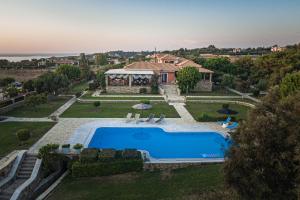 an aerial view of a house with a swimming pool at Villa Belvedere in Agios Andreas