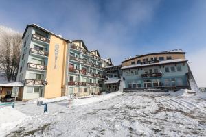 a group of buildings in the snow at Hills View Apartment in Donovaly