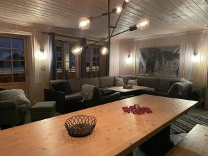 a living room with a table and a couch at Tinden in Hemsedal