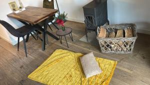 a living room with a table and a fireplace at Hof van Bommerig in Mechelen