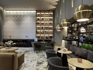 a lobby with tables and chairs and a fireplace at Heritage Hill Hotel in Athens