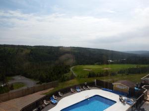 a view of a pool and a golf course at The Wilds at Salmonier River in Salmonier Nature Park