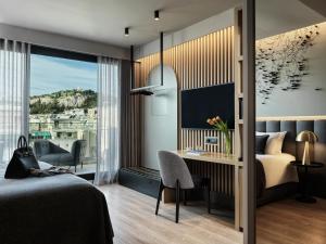 a bedroom with a bed and a desk with a computer at Heritage Hill Hotel in Athens