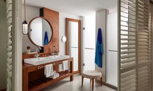 a bathroom with a sink and a mirror at C Mauritius in Belle Mare