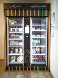 a refrigerator filled with lots of food and drinks at OHO Rooms Geisingen - Digital Access Only in Geisingen