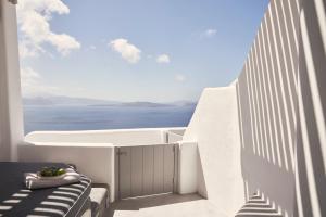 a view of the ocean from the balcony of a house at Alisaris Cave Suites in Oia