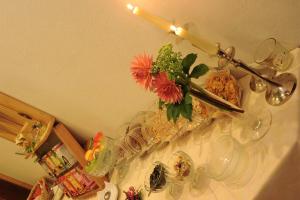 a table with a vase with flowers on a shelf at Haus Schönlechner in Gaschurn