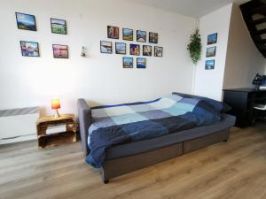 a bedroom with a bed and pictures on the wall at LE DUPLEX - Hyper centre - Gare - Wifi - Duplex in Annecy