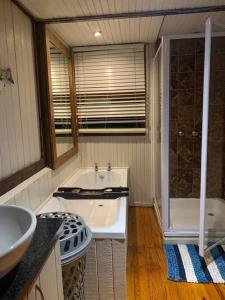 a bathroom with a tub and a sink and a shower at Sodwana Bay Lodge, House 31 in Sodwana Bay +10 photos