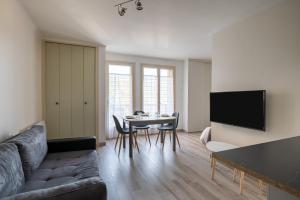 a living room with a couch and a table at Le Thalasso in Amélie-les-Bains-Palalda