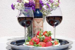 two glasses of wine and strawberries on a table at Fantastic 1 bedroom apartment in the centre of Nerja in Nerja