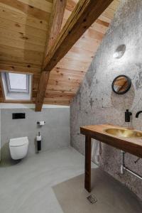 a bathroom with a sink and a toilet at Das Fort Boutique in Râşnov