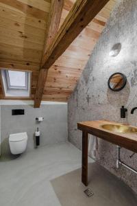 a bathroom with a sink and a toilet at Das Fort Boutique in Râşnov +92 photos
