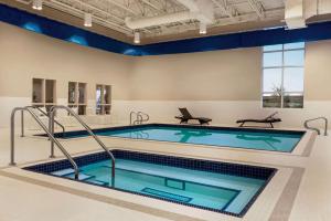 a swimming pool in a large room with a large window at Microtel Inn & Suites by Wyndham Aurora in Aurora