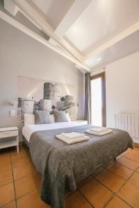 a bedroom with a large bed with two towels on it at La Albacara in Moya