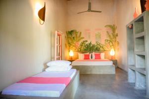 a room with two beds in a room at Villa Don Bastian in Tangalle