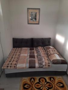 a bed in a room with a bed frame at Apartman Vuk in Pale
