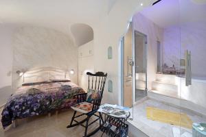 a bedroom with a bed and a glass walk in shower at La stanza segreta platinum in Dolceacqua